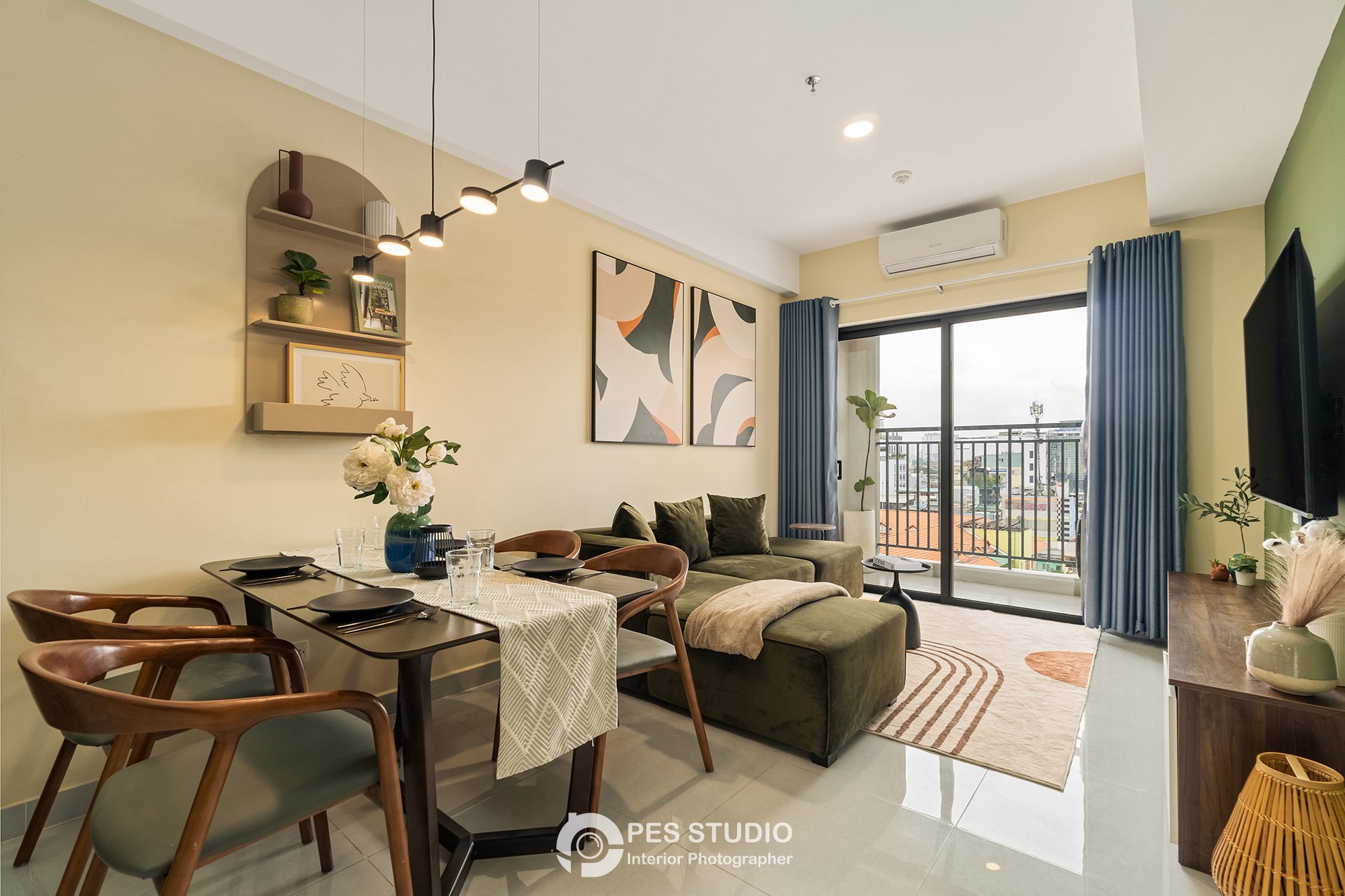 Bàn ăn dài căn hộ Soho Residence với ghế gỗ và cửa kính ra ban công